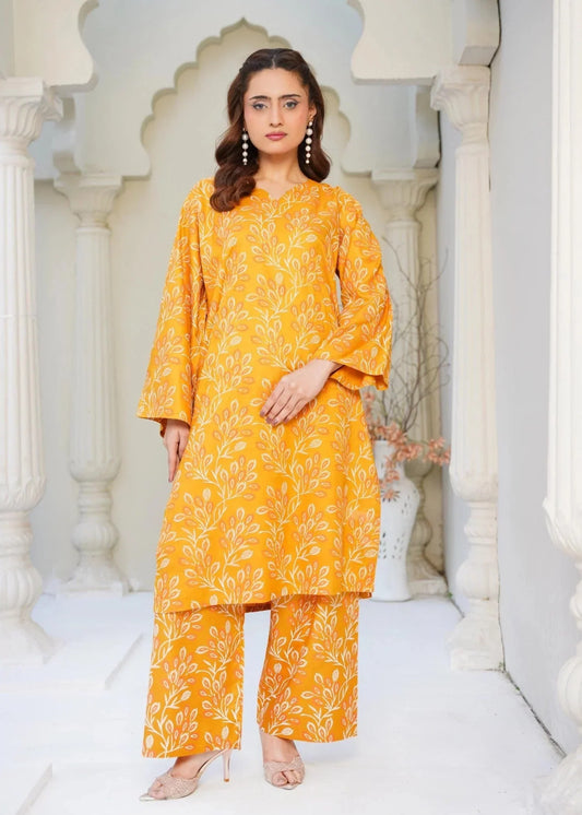 Woman wearing a yellow patterned outfit standing in an ornate architectural setting.