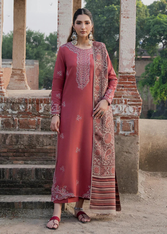 Woman in a traditional outfit standing in an outdoor setting with architectural elements.